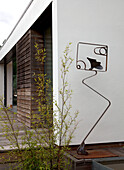 Metal sculpture and plant outside modern extension of Essex home UK