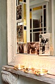 Close up of French greeting cards displayed on mirror frame lit by nightlights