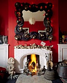 An eclectic mix of found objects and handmade mirror over fireplace