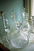 Display of antique cut glass bottles and decanters
