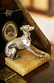Close up of silver dog paperweight on writing desk