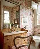 Vintage wallpapered bathroom with furniture