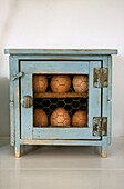 Small blue cupboard containing eggs