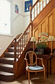 Wooden staircase from hallway with banisters