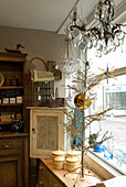 Shop window filled with antique and second hand furniture and lighting