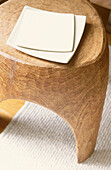 Square-shaped plates on natural wood stool