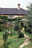 Garden exterior of Edwardian brick cottage in Suffolk