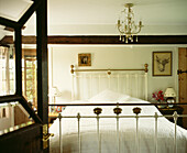 Glazed bedroom door and brass bed with chandelier 