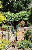 Gated patio of Suffolk terrace in garden of farm workers cottage