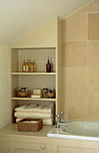 Neutral bathroom in coach house renovation with fitted shelving 