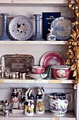 Antique collectables on shelving in antique shop