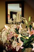 Lilies and gypsum in living room with mirror