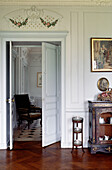 French apartment doorway with antique furniture and artwork
