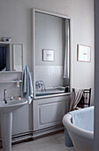 Large mirror and reflection with light blue towels in French bathroom