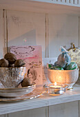 Vintage bone china cups holding walnuts and Amaretti on the dresser shelf