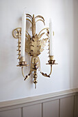 Gilded wall sconce with candles