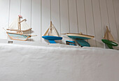 Model sailing boats on wall beam low angle view