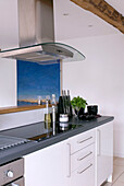 Modern kitchen with glass stove and hood