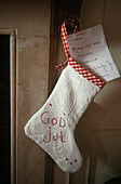Christmas stocking hanging on wall with letter inside