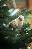 Decorative dove sitting in christmas tree