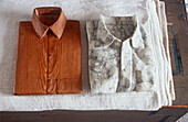 Wooden and marble sculptures in shape of shirts