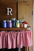 Multi coloured paint jars on shelf