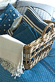 Various blue textiles in wicker basket