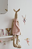 Stuffed toy on shelf by fairy decorations