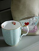 Mug and tea cosy of a tabletop
