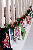 Staircase banisters decorated with Christmas decorations and cards