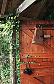 Binoculars hanging on handle on wooden door