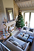 Christmas tree in Wiltshire farmhouse with wood burning stove elevated view