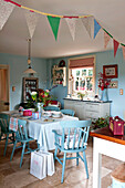Table and chairs in kitchen with bunting