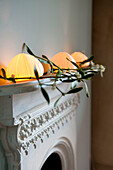 Fairy lights and mistletoe on painted original fireplace