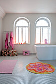 Arched windows in tiled Odense bathroom