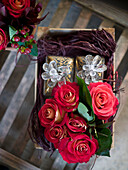 Red roses and gifts in Christmas crate