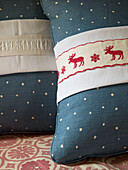 Two spotted cushions with Christmas detail