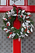 Christmas garland on red front door of London home UK