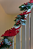 Handmade Christmas decorations on banister in London home UK
