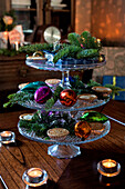 Mince pies and Christmas baubles on glass cake stand in London home UK