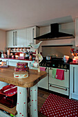 Cake tins on work surface of country style kitchen in London home UK