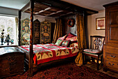 Four poster bed with travelling chest in Cheltenham country home Gloucestershire England UK