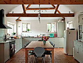 Beamed ceiling in open plan kitchen of Suffolk home England UK
