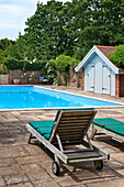 Poolside sunloungers in grounds of Canterbury home England UK