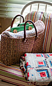 Patchwork quilt and basket with toy car in London home England UK