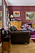 Assorted fabrics and patterns in living room with antique box in living room of London home UK
