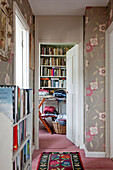 Floral patterned wallpaper in hallway of London home UK