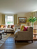 Assorted cushions on sofas in drawing room of West London townhouse England UK