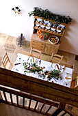 Kitchen dresser and dining table viewed from mezzanine of rural Suffolk home England UK