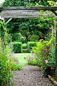 Woodchip path and pergola in grounds of rural Suffolk country house England UK